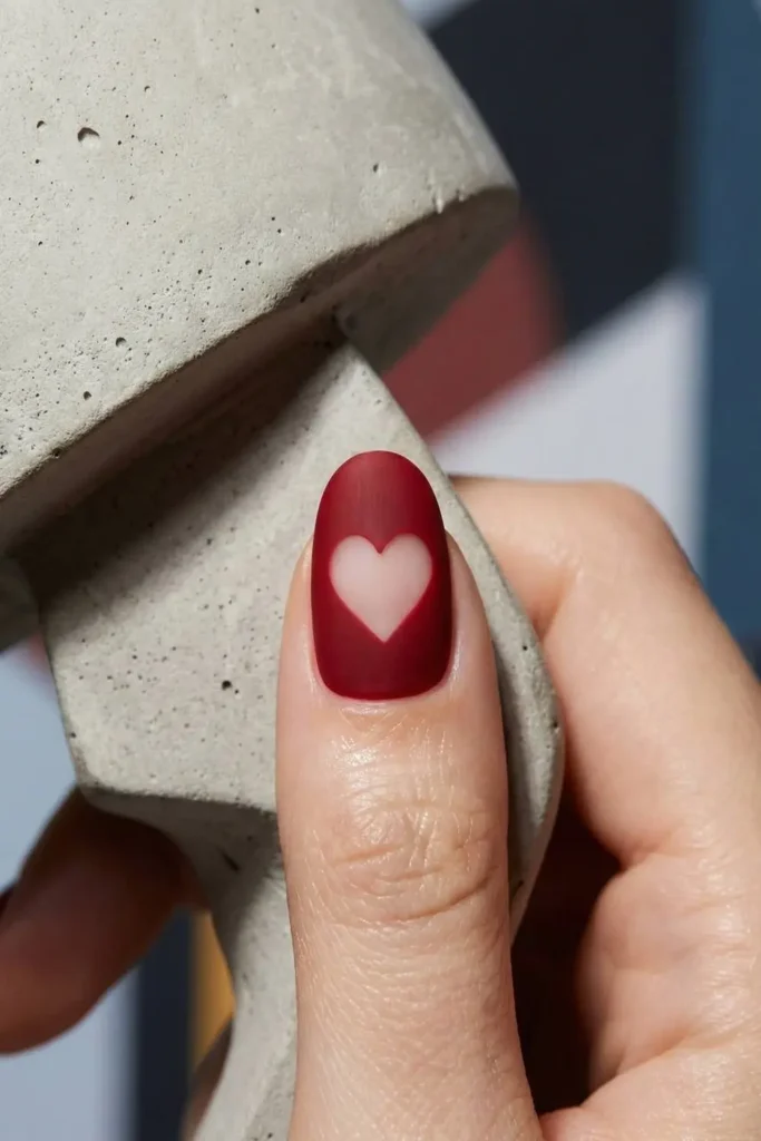 Negative space heart nail art design.