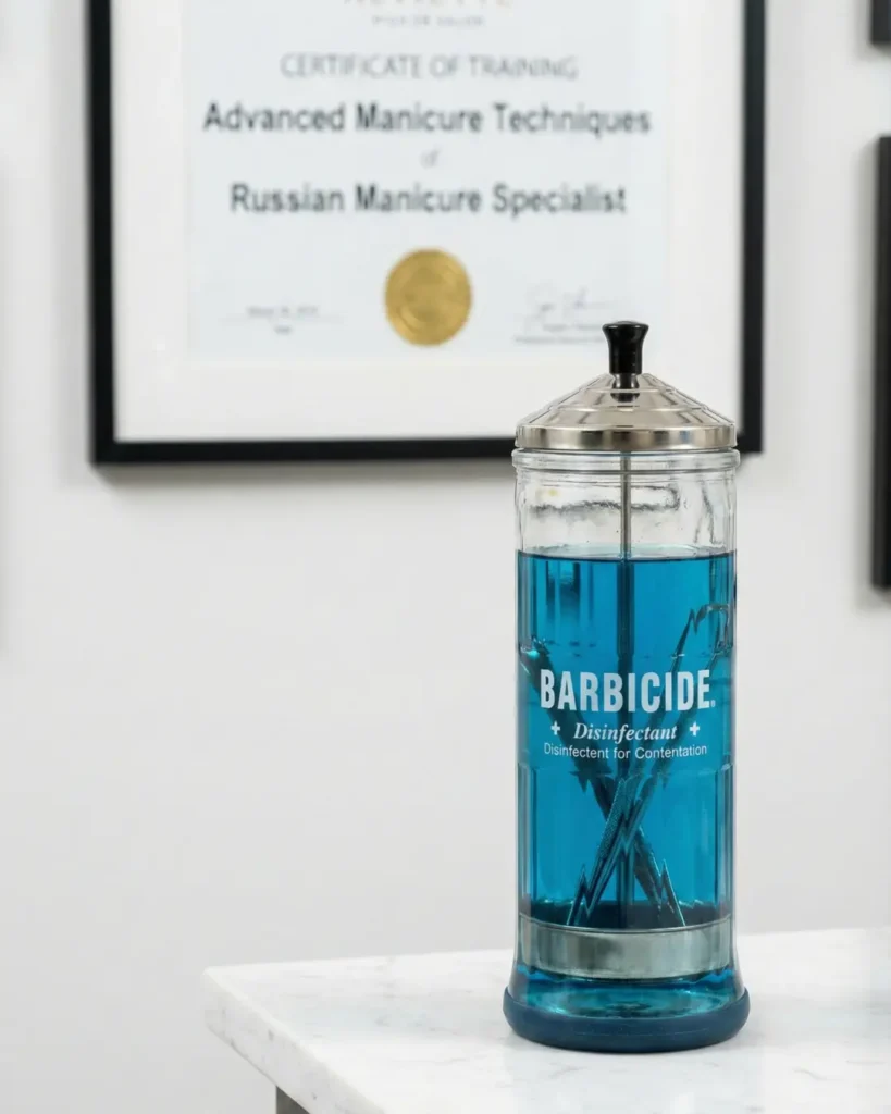 Professional salon certification and clean tools indicating a safe environment for Russian manicures.
