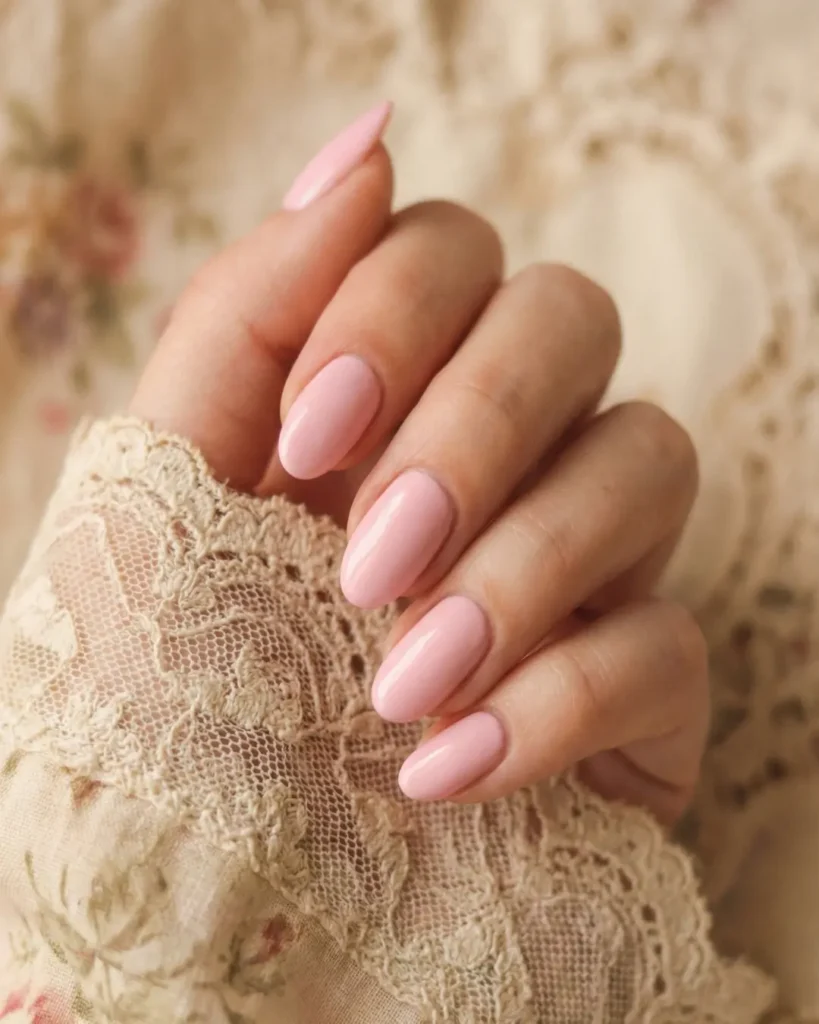 Soft oval nail shape painted in pastel pink, mimicking the natural curvature of the fingertip.