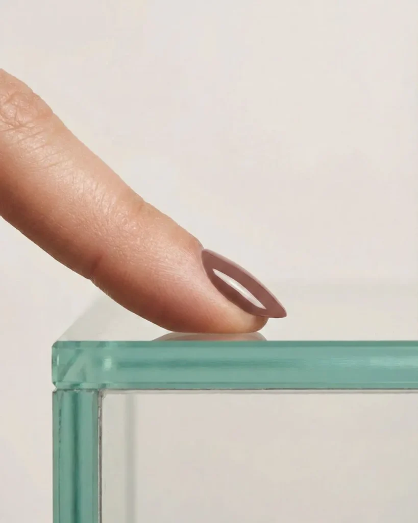 Demonstration of nail strength and durability showing the apex structure of a gel manicure.