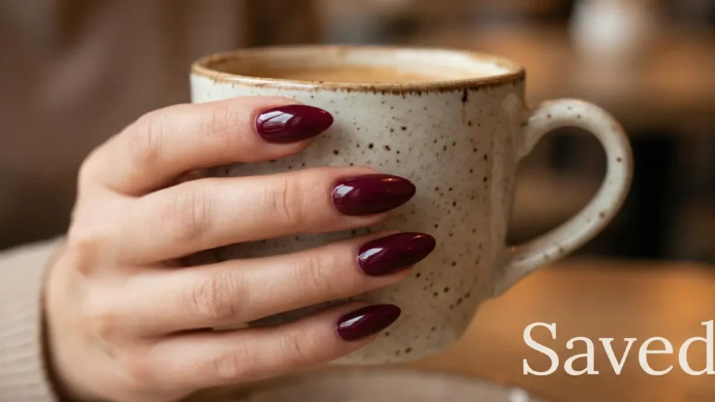 Perfectly repaired manicure holding a mug.